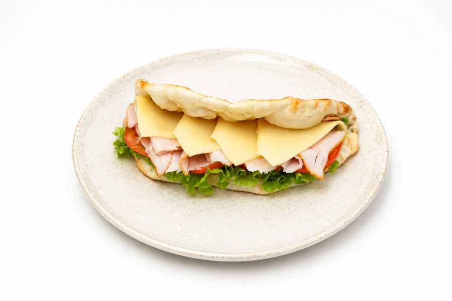 A sandwich-pizza with ham and cheese