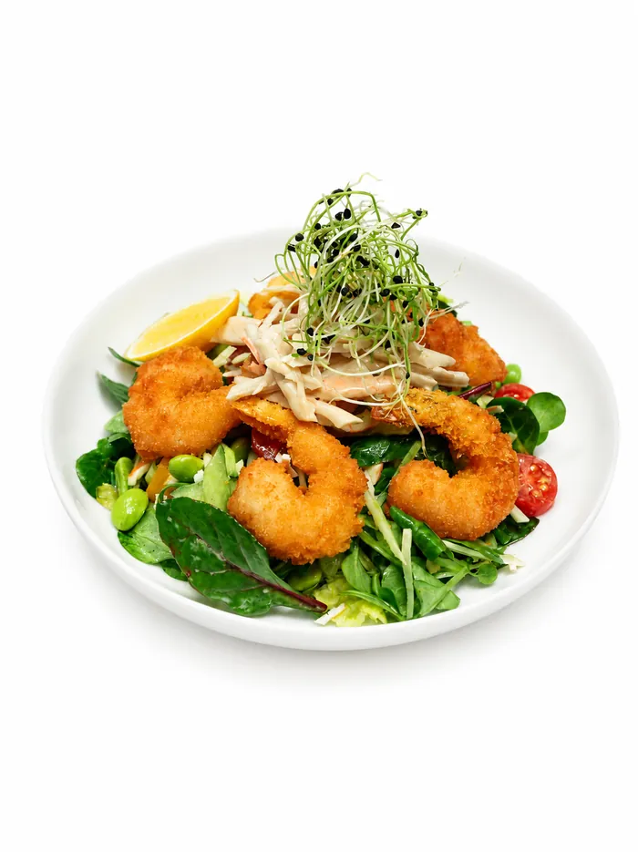 A salad with popcorn shrimp